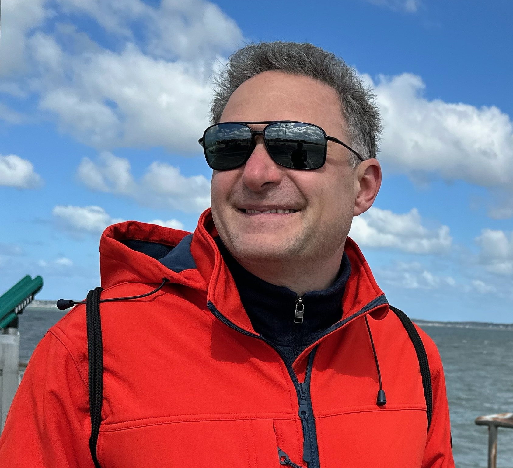 Dmitry Braverman seated outdoors in a sunny square